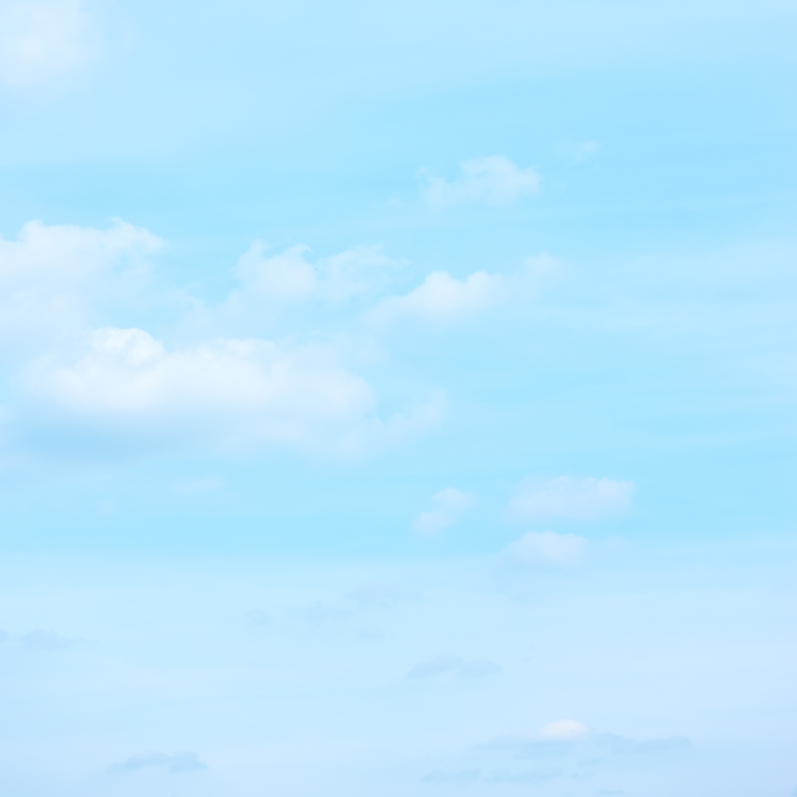 Light pastel blue sky small clouds